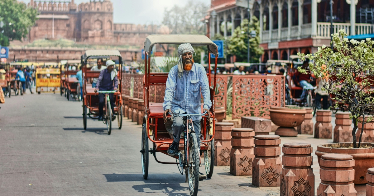 Tricycle Rickshaws riding on a street near Chandni Chowk market, Delhi, India
